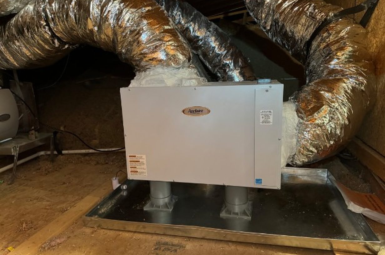 Aprilaire whole-home dehumidifier installed in an attic, ducts sealed with mastic